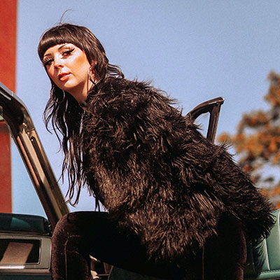 a model wearing fluffy black coat for women