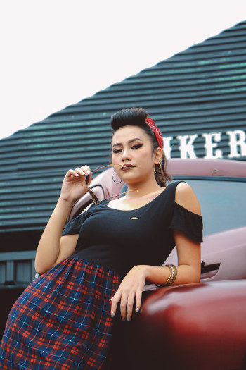 image of a young girl wearing a second-hand outfit and holding an old fashioned camera